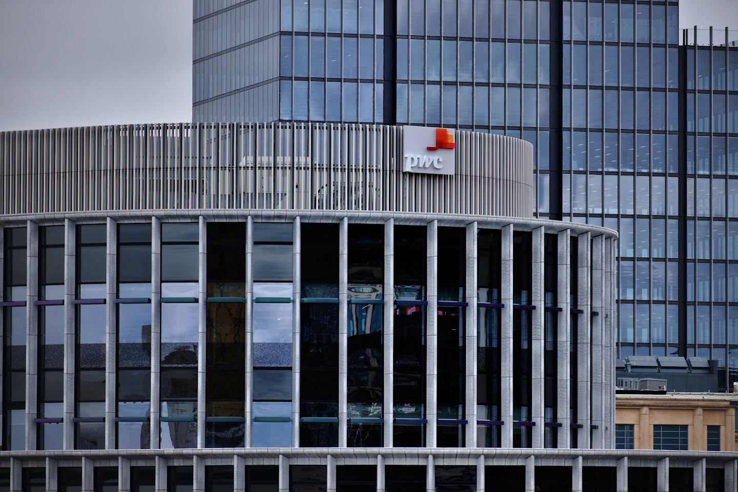 PWC corporate building with metallic fins and glass windows.